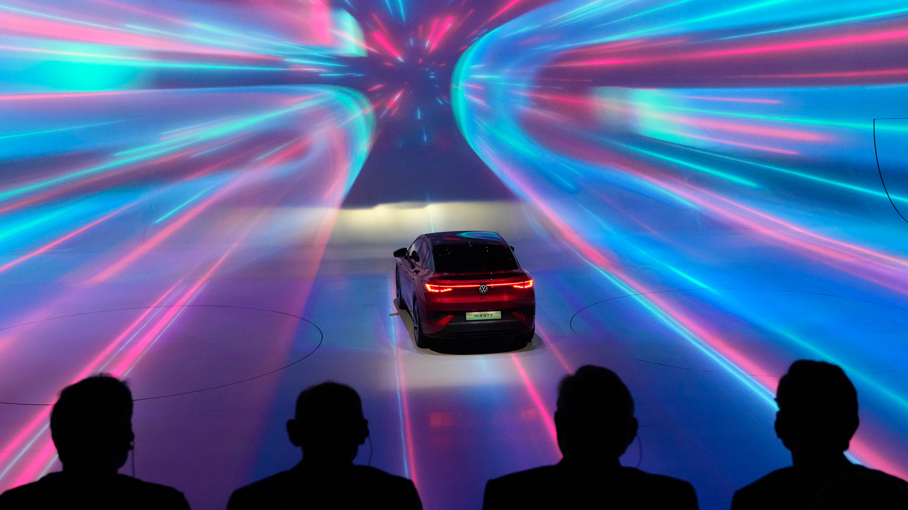 Attendees watch a dramatically light show presentation of Volkswagen&#039;s latest vehicles on the eve of the Auto Shanghai 2023