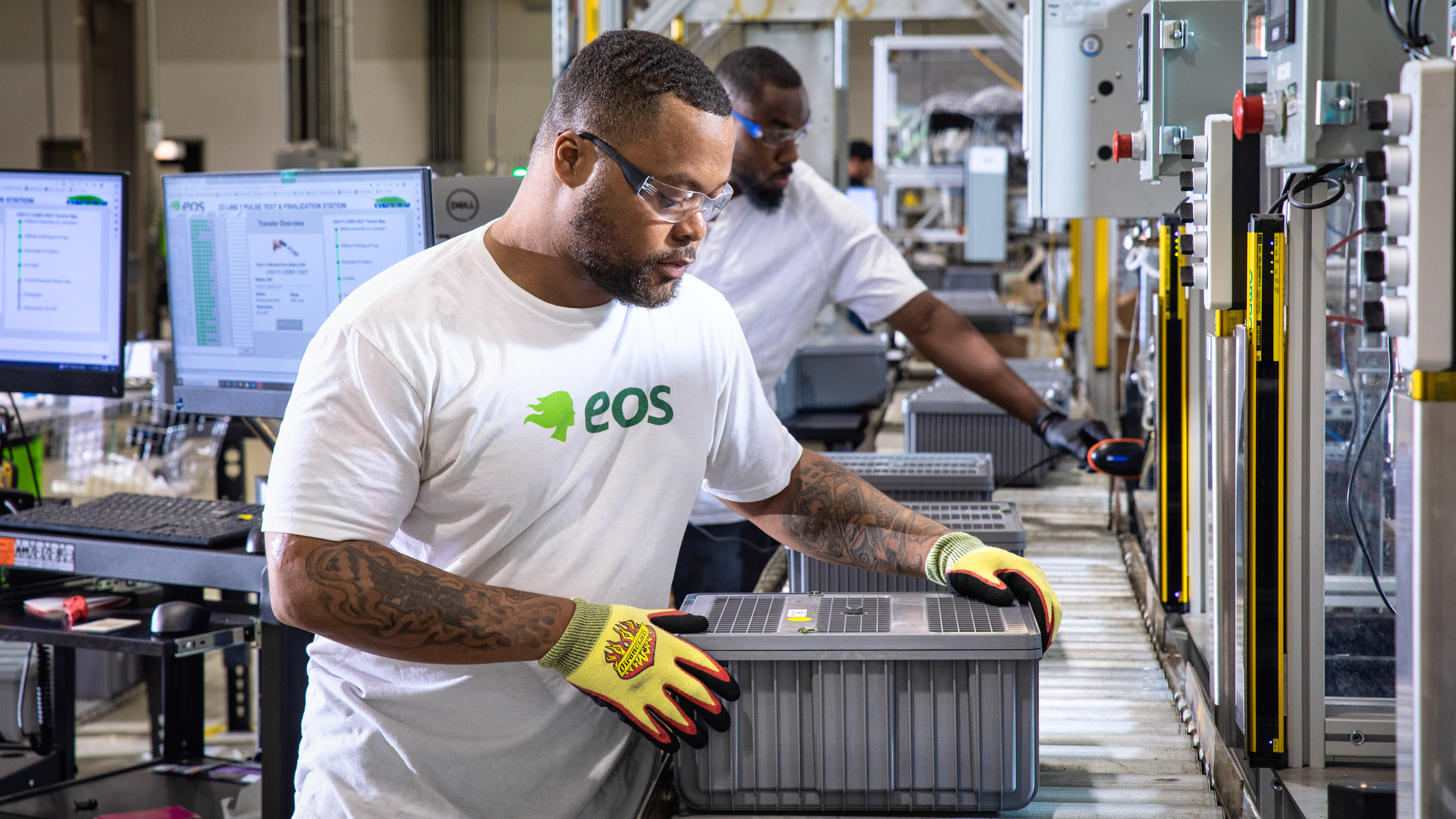 Employees Joe Jackson and Baron Mason testing batteries as a final product at the eos assembly line