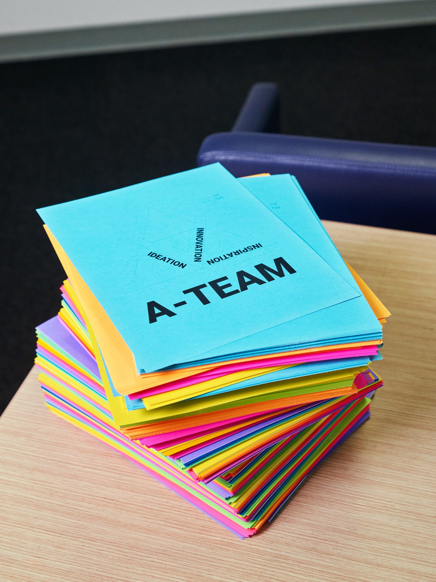 tall stack of florescent colored cards that read "A-Team"