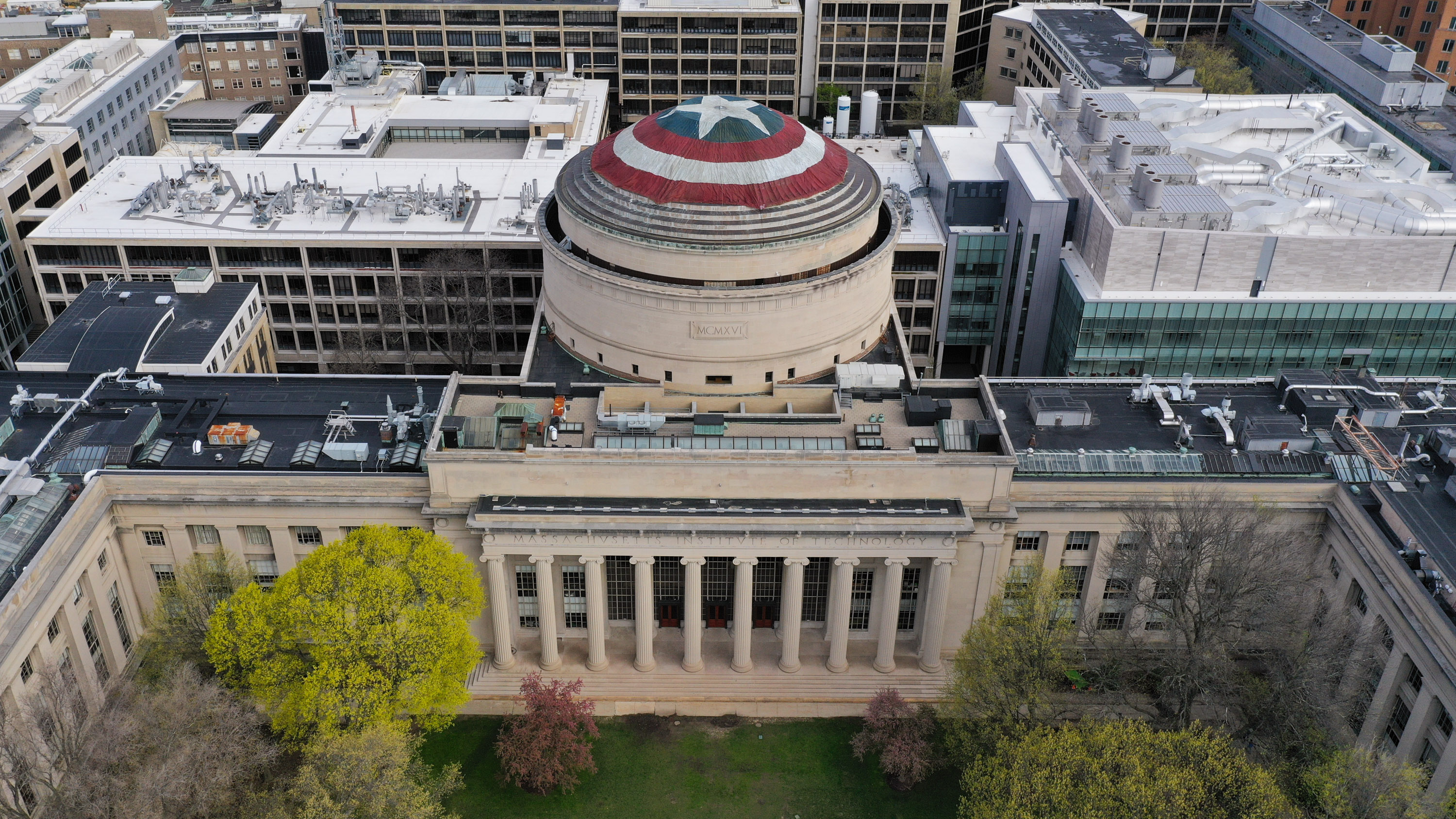 a drone view of the dome at MIT draped with Captain America&#039;s shield