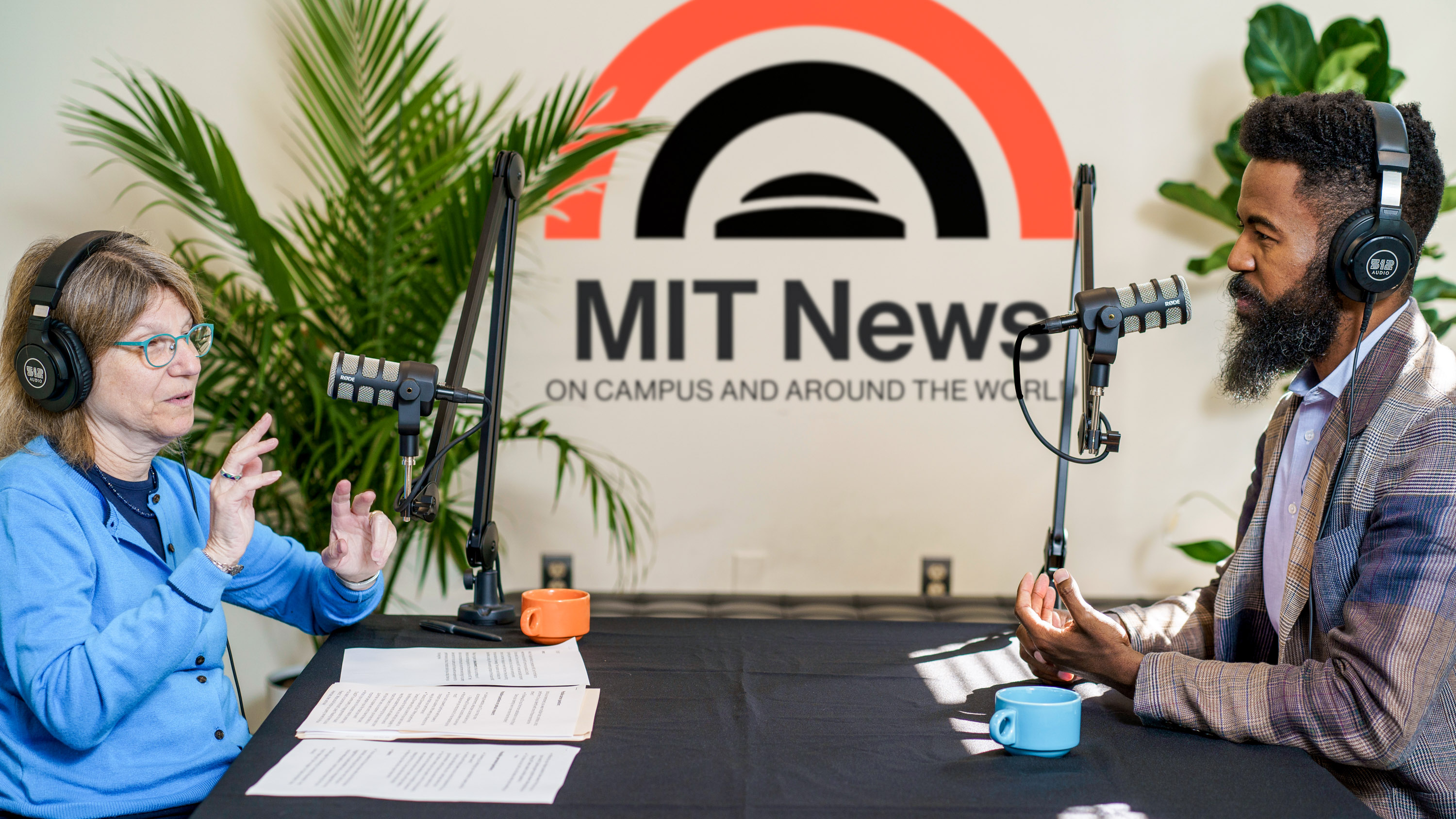 MIT President Dr. Sally Kornbluth interviewing Dr. Joshua Bennett with the MIT News logo seen between them on the wall