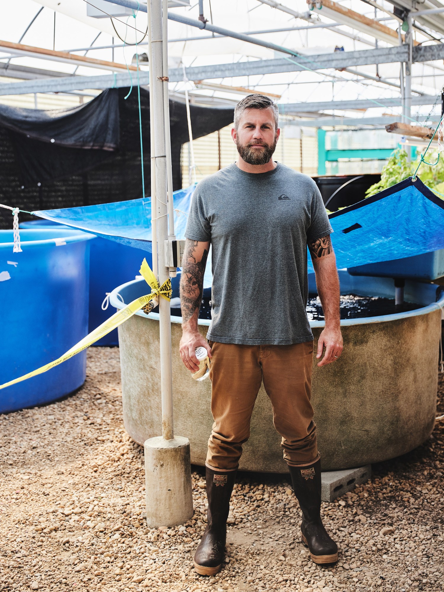 Ed Hale in waders by aquaculture tanks