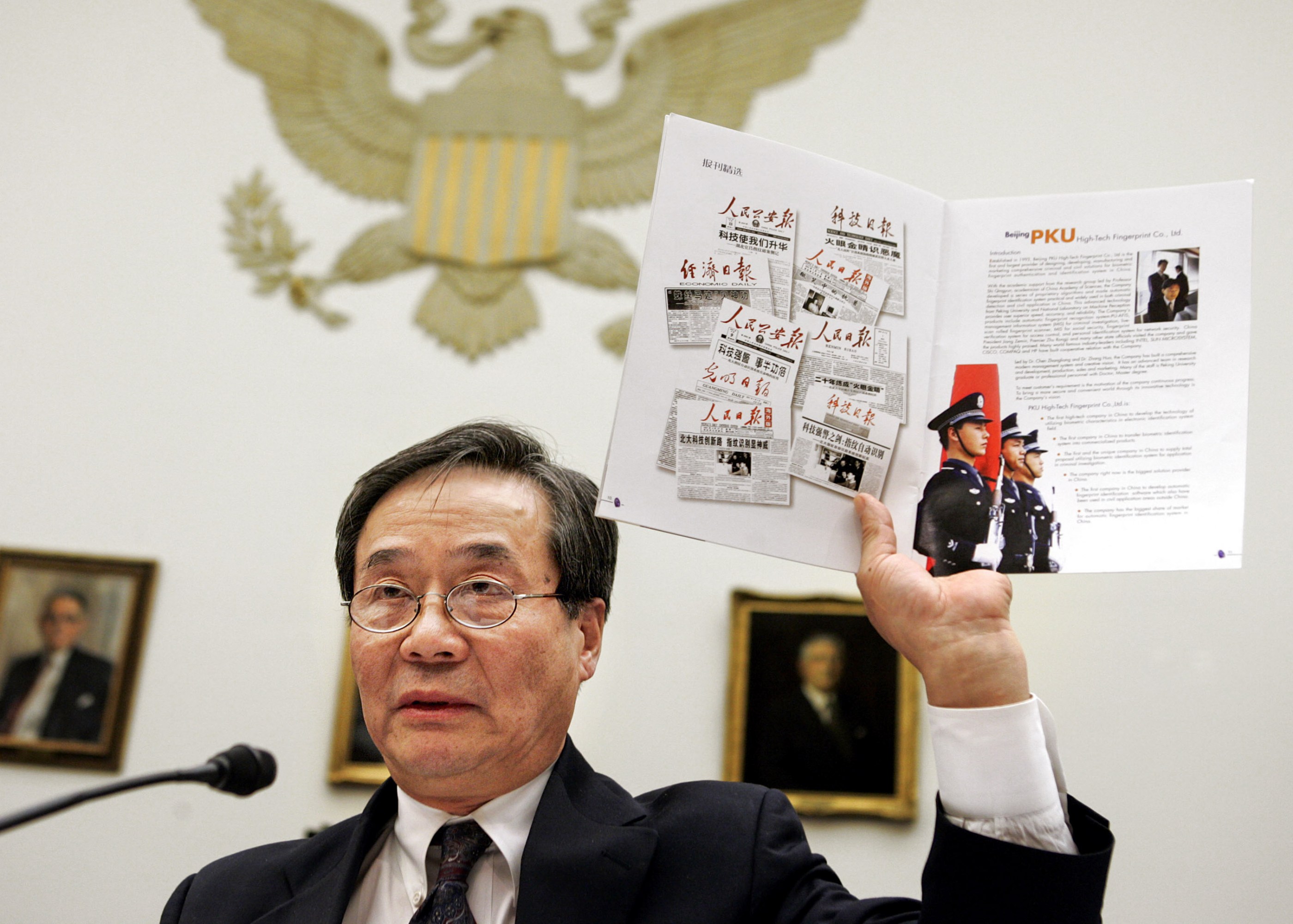 Harry Wu holds up clippings during subcommittee testimony