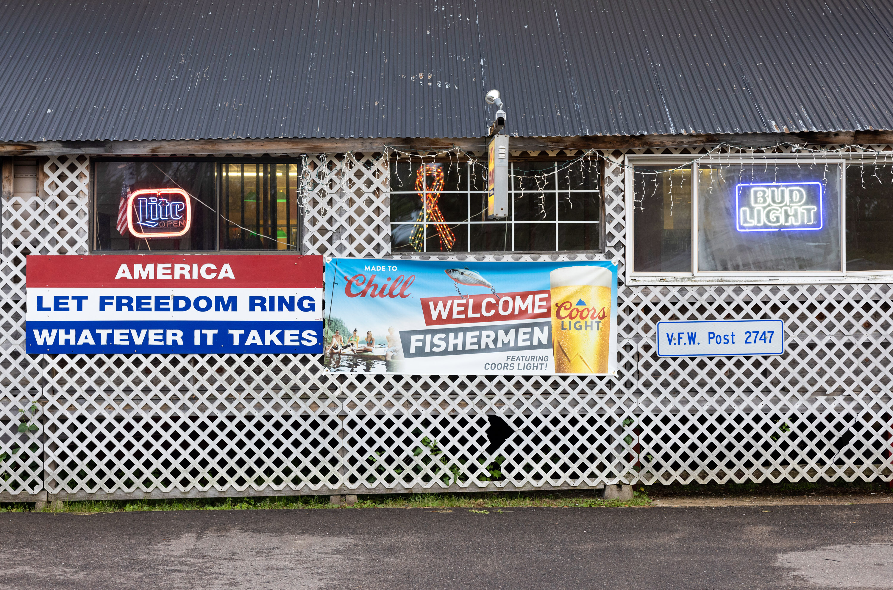 Signs on the side of the VFW read "America Let Freedom Ring Whatever it Takes" and "Welcome Fisherman"