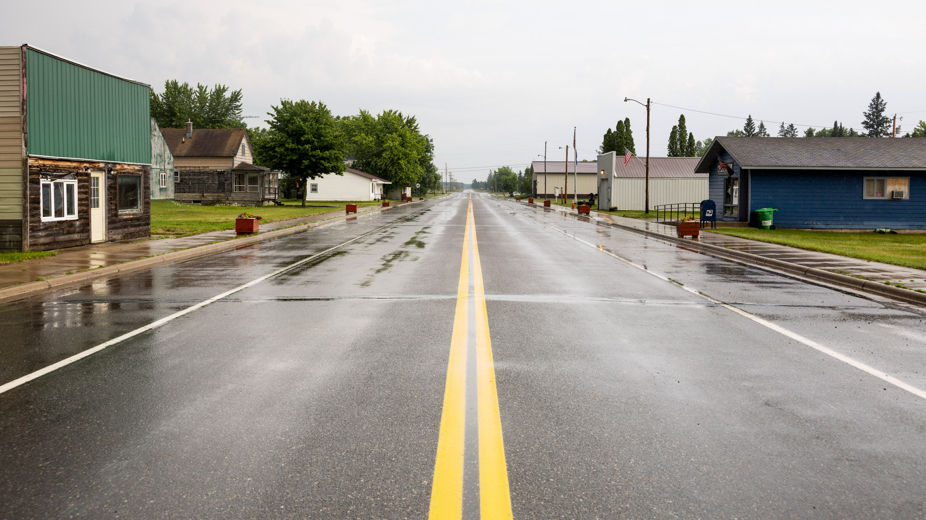 a view from the median line of an empty Main Street, Tamarack MN after a recent rain shower