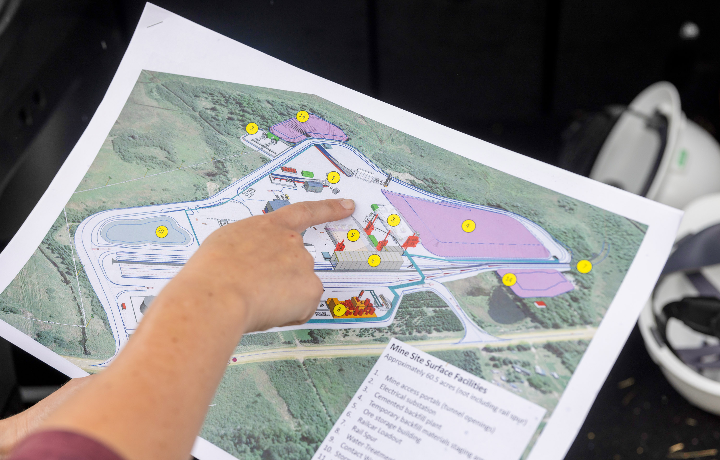 hand pointing to a printed map of the Tamarack site
