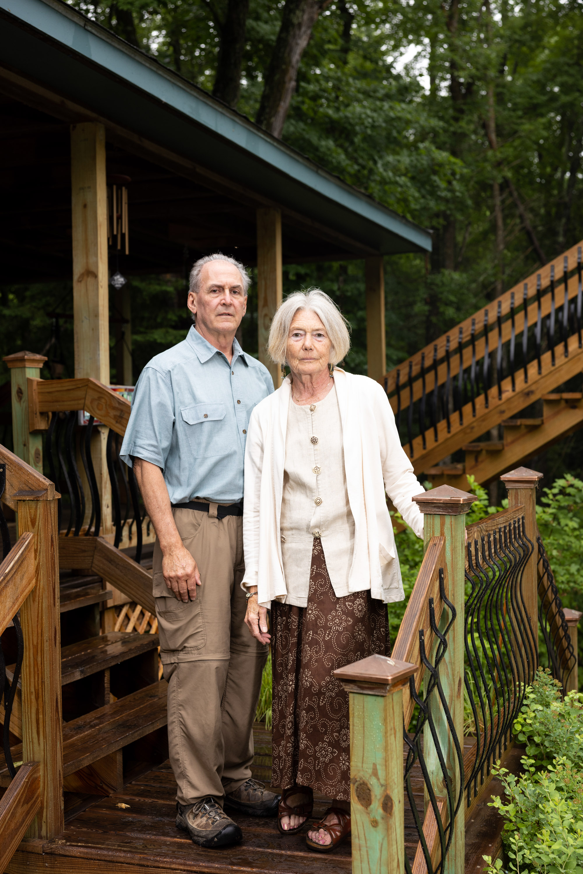 Lynn and Tom Anderson standing on the wooden steps of their home