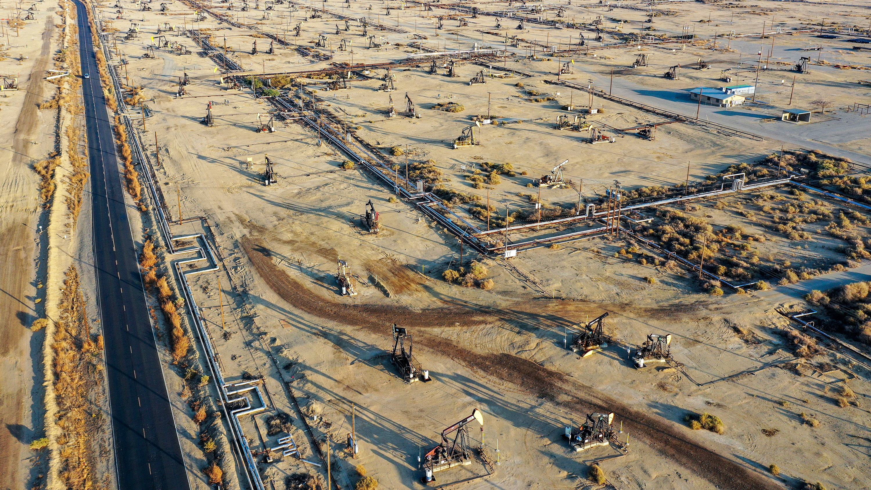 In an aerial view, some pumpjacks operate while others stand idle in the Belridge,CA oil field