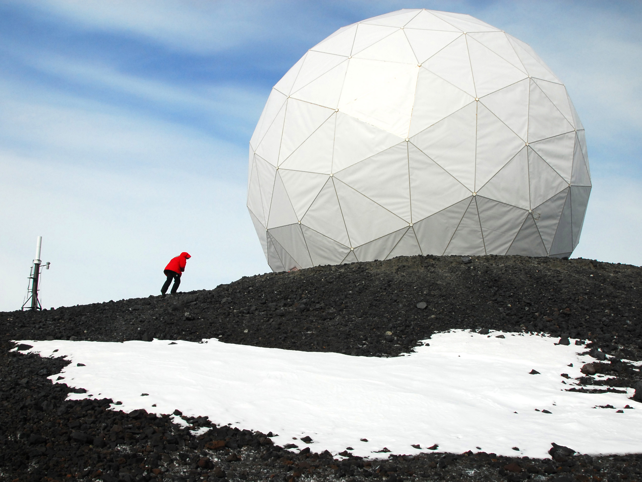 a person walking up to a radio dome