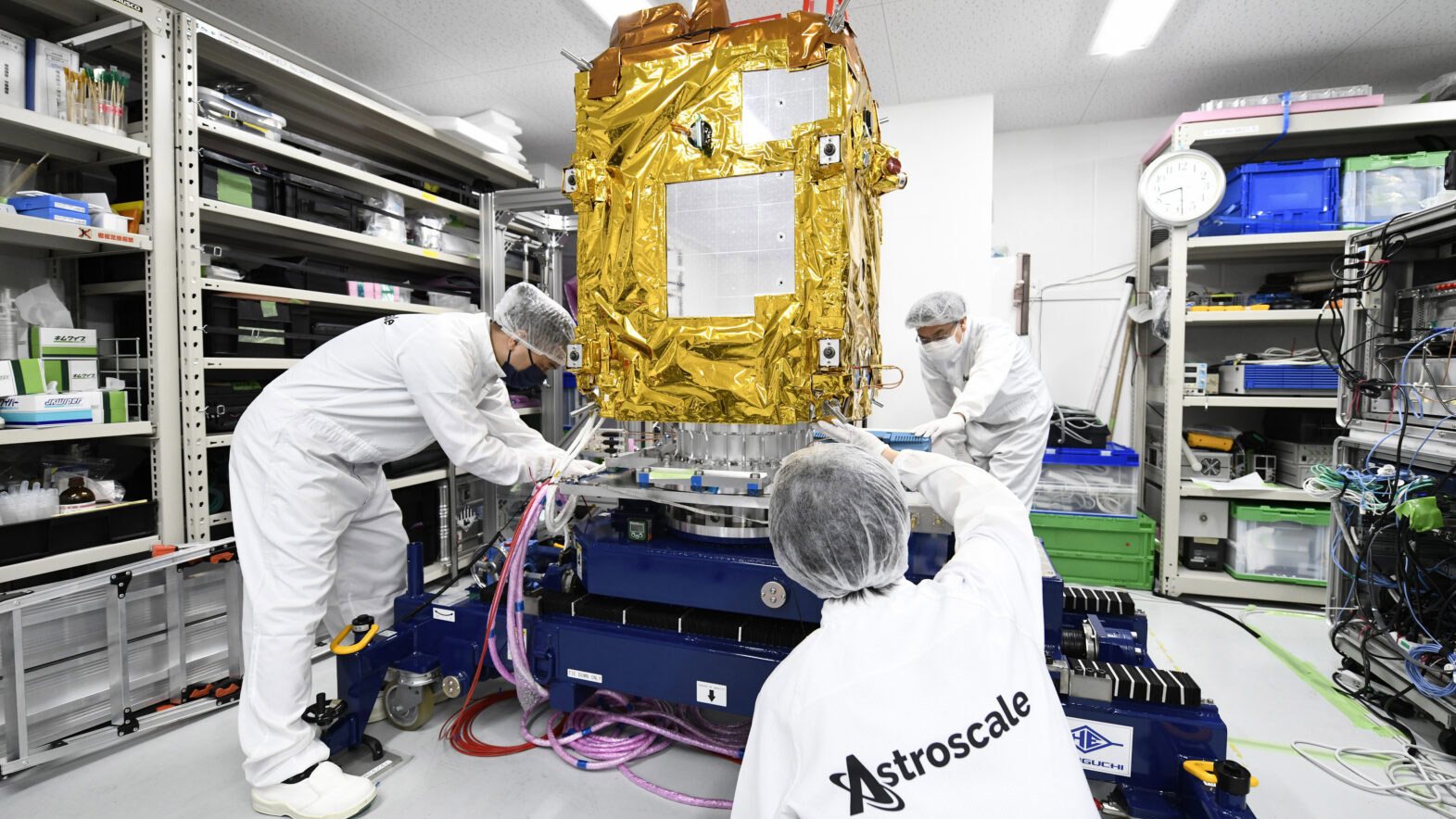 Astroscale workers in cleansuits prepare Adras-J for its mission