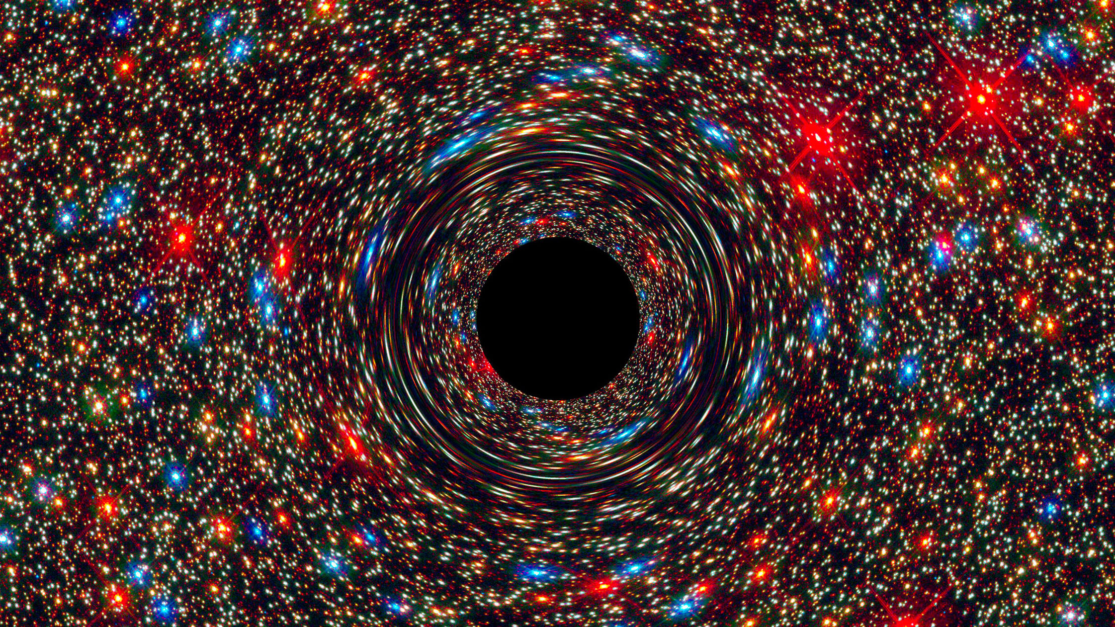 A computer-simulated image shows a supermassive black hole at the core of a galaxy.