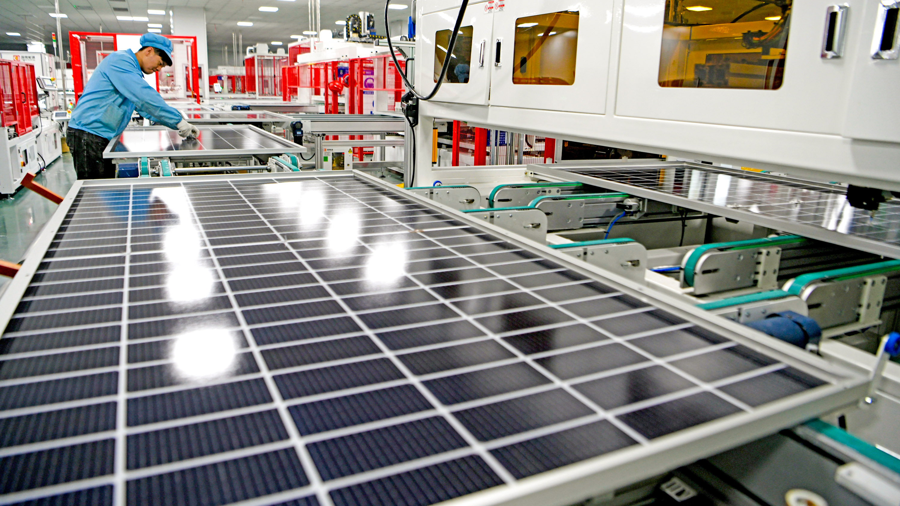 An employee works on the production line of solar panels in Huainan, China