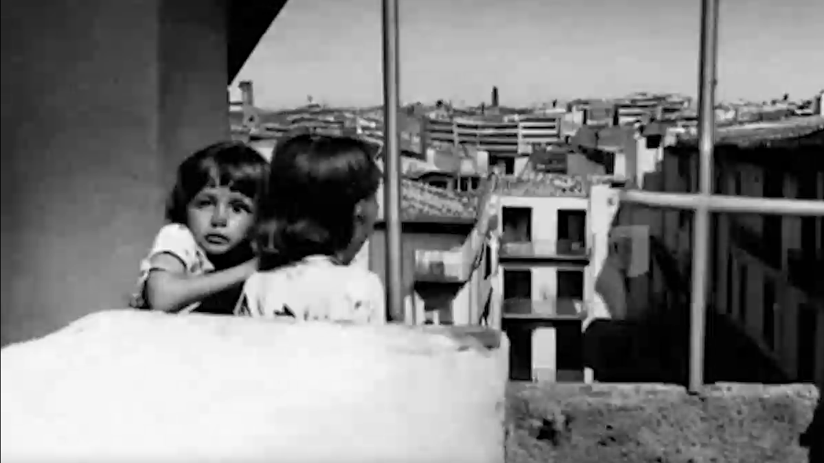 ai generated B&W image of two children looking over a balcony at a city buildings below